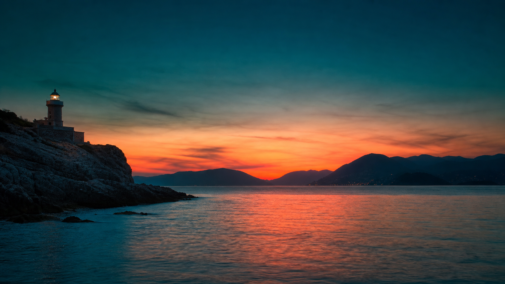 Il Golfo dei Poeti a La Spezia al crepuscolo, con un faro acceso sulla punta rocciosa e il mare calmo che riflette i toni corallo e verde petrolio del cielo